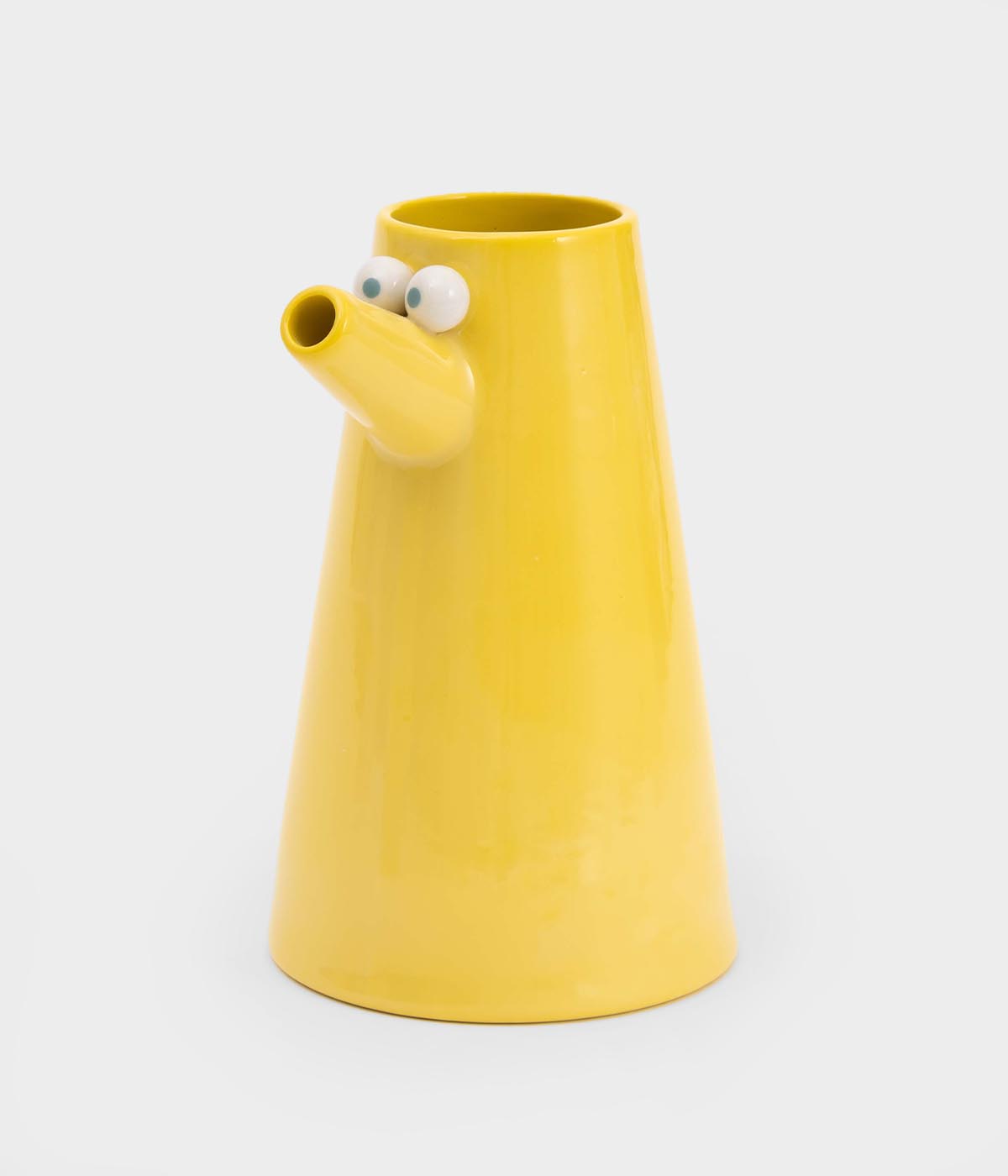 Yellow vase with googly eyes on a white background, Lucas Zanotto