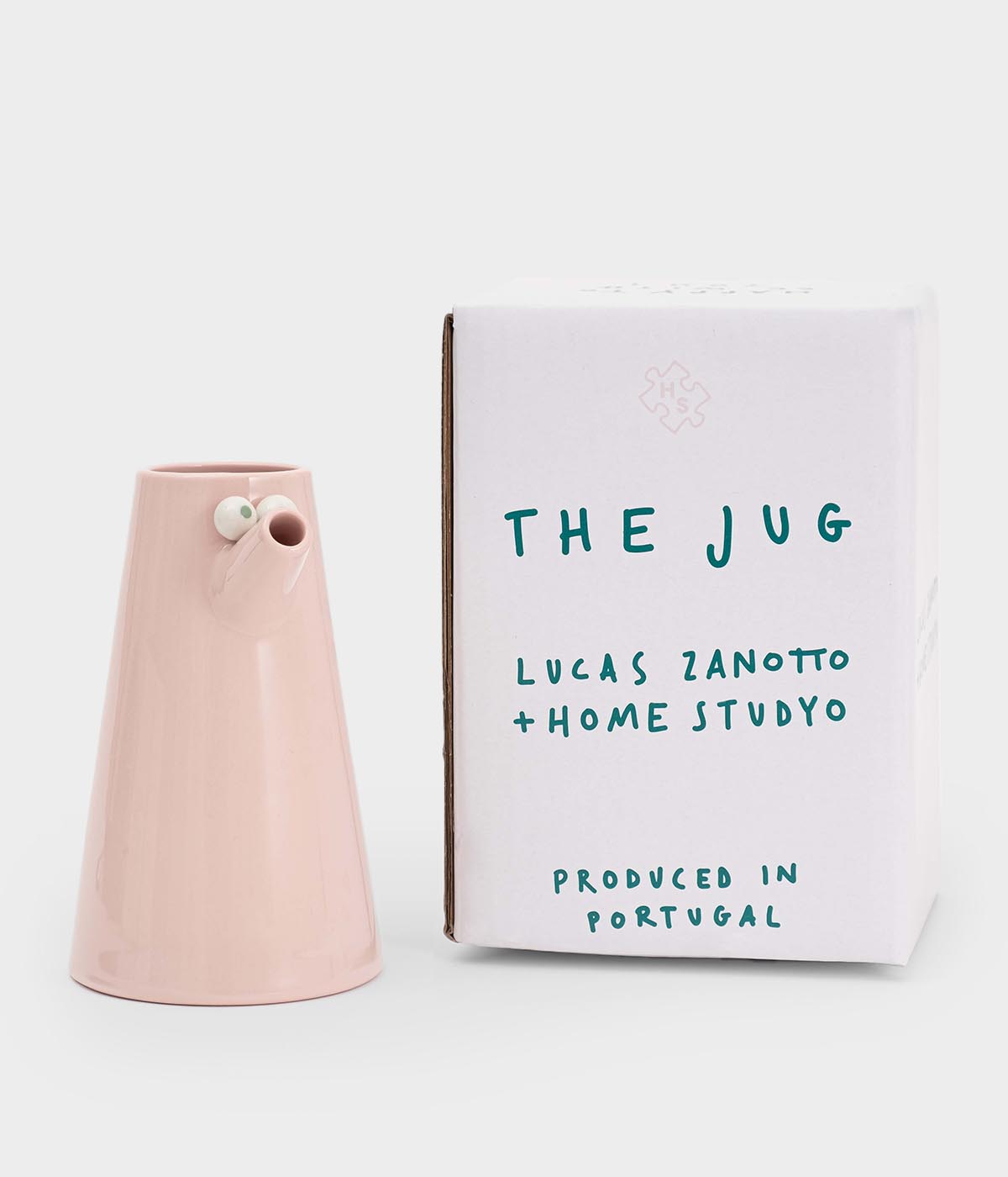 Pink ceramic jug next to a white box with 'The Jug' branding on a light gray background, Lucas Zanotto